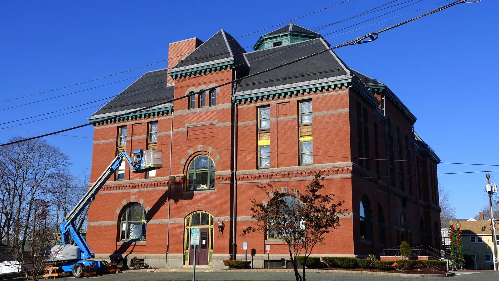 Stoughton Town Hall, a red-brick Victorian civic building with a slate hip roof and copper cupola, Stoughton, Massachusetts